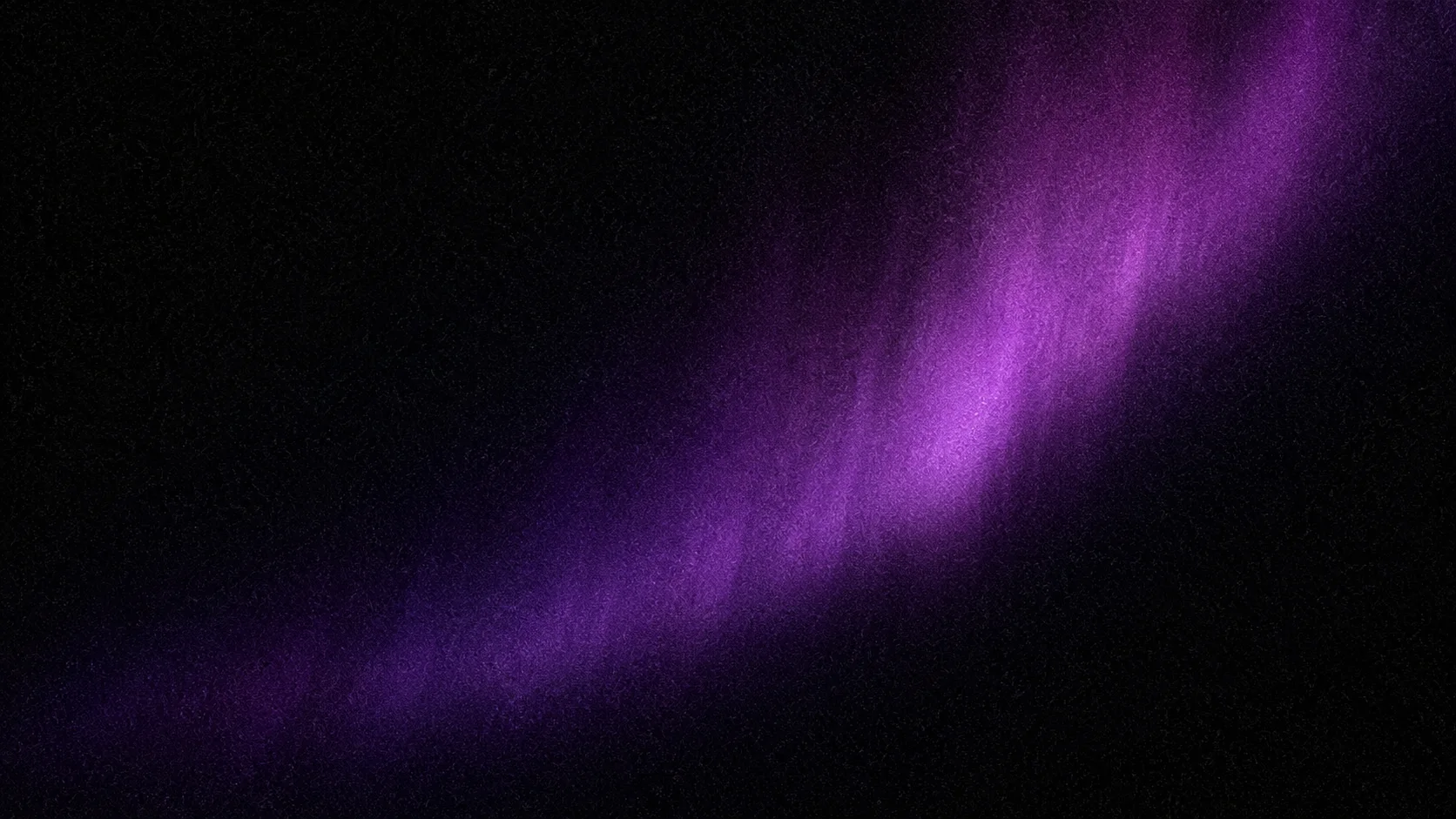 A grain of violet light dispersed across deep shadow