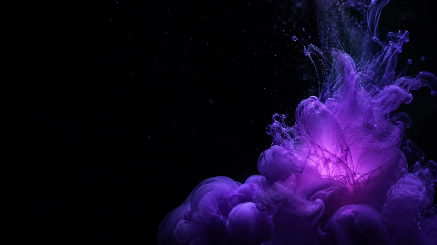 Dark ink blooming and dispersing through clear liquid